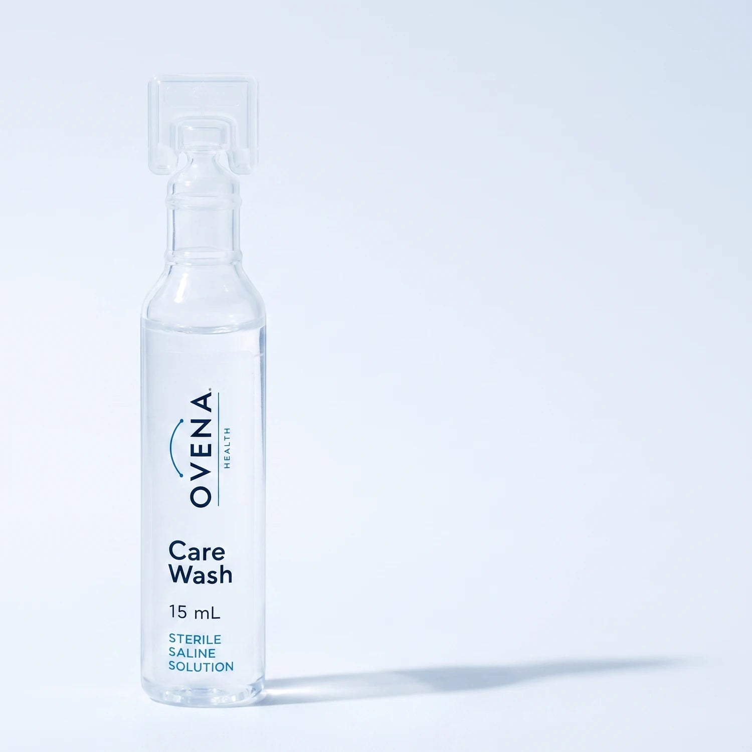 A single Ovena Care Wash 15 mL saline ampoule, photographed close up